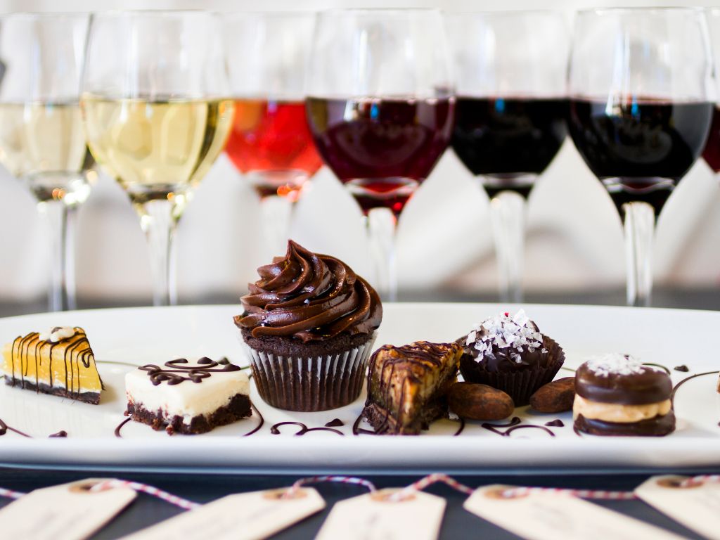 Ice wine food pairings - white, rose, and red wines in glasses paired with sweet desserts