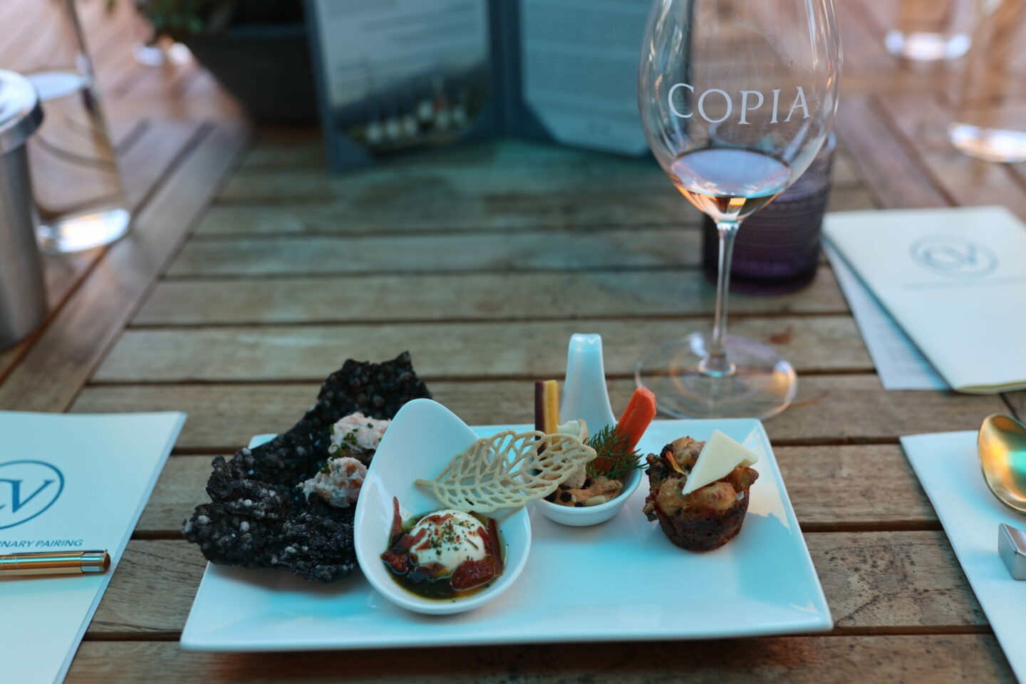 Food on a table with a Copia wine glass- Paso Robles Wineries