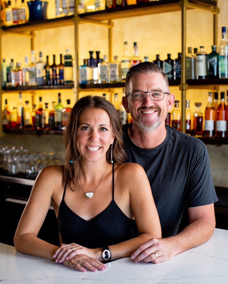 A man and a woman dressed in black at Della's Wood-Fired Pizza -Paso Robles Wineries