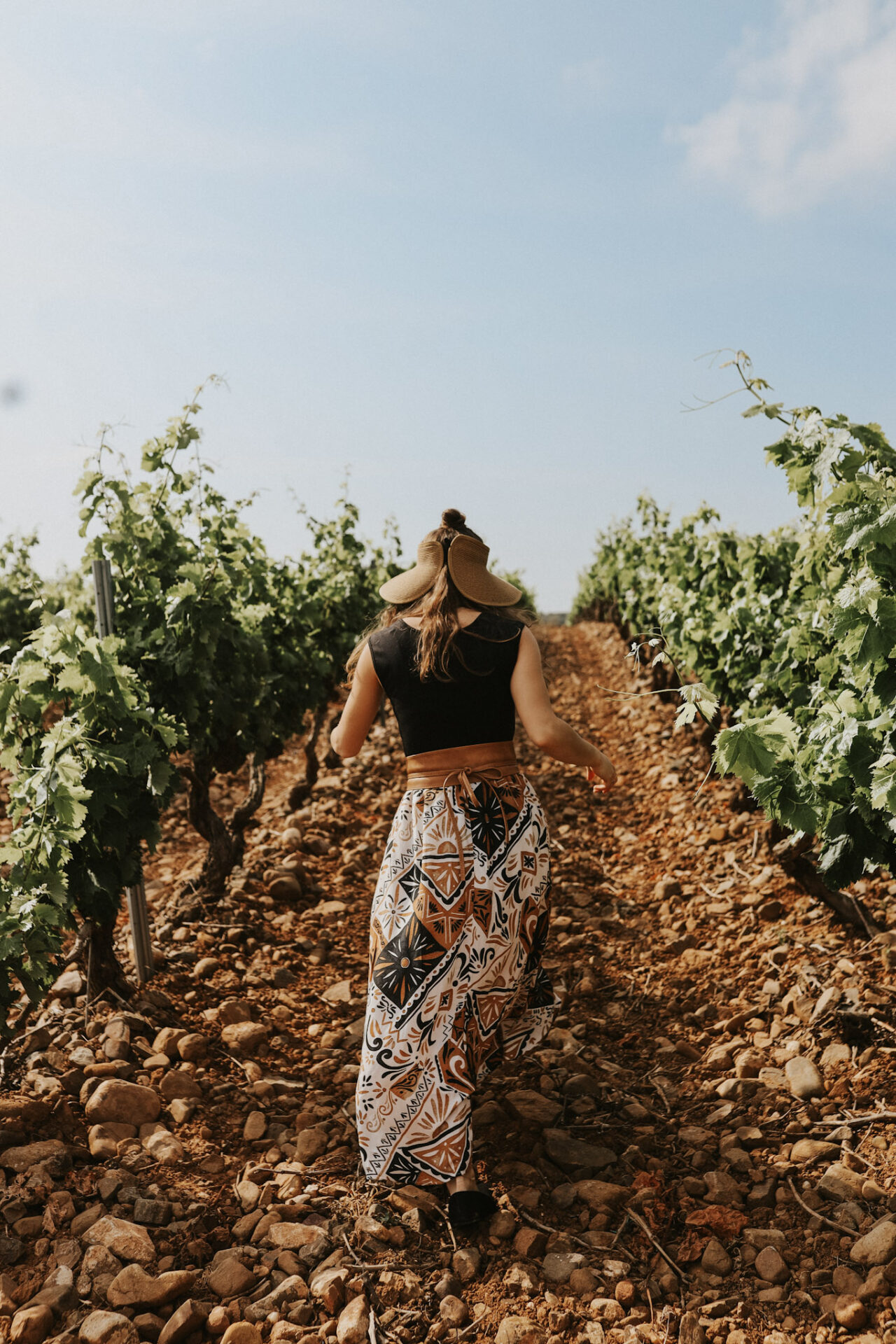 A lady walking in a Portuguese wine valley