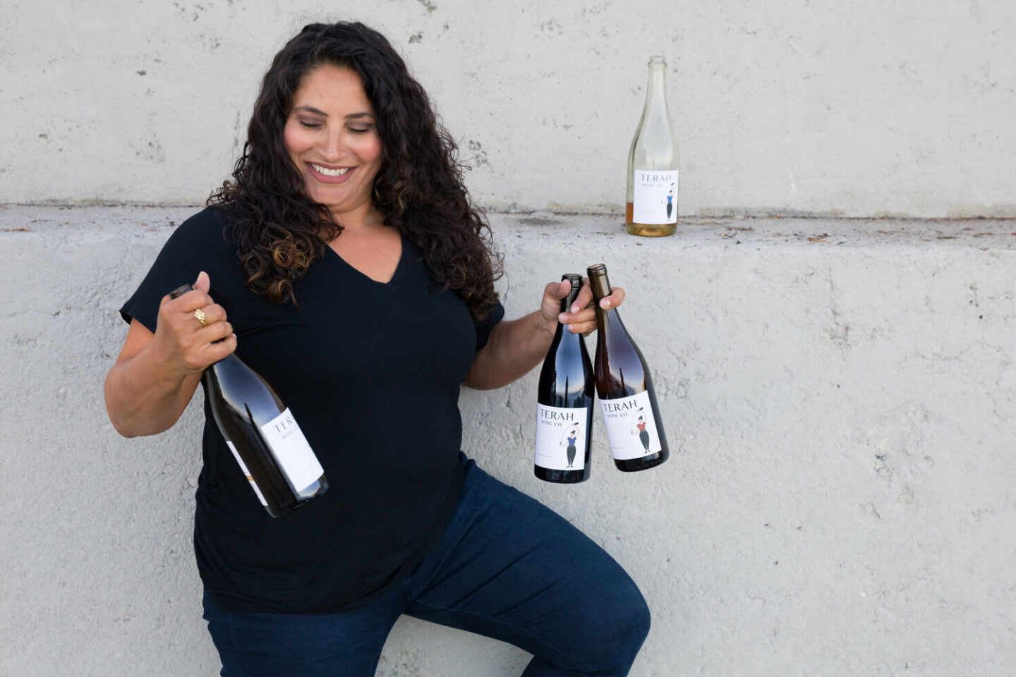 A woman holding bottles of LGBTQ+ wines
