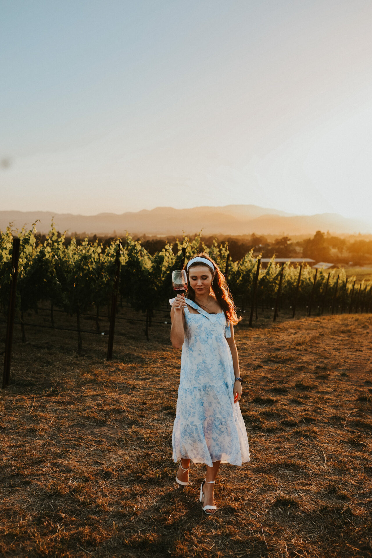 California Wine Regions- A lady holding a glass of wine