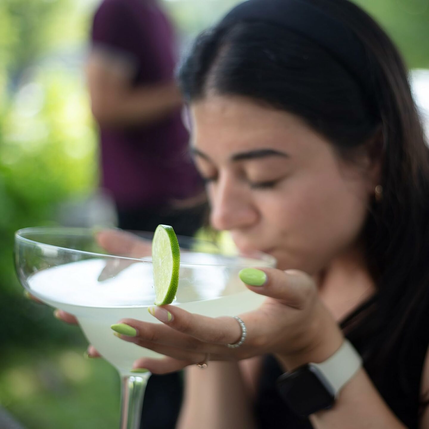 Girl sipping large cocktail out of oversized glass