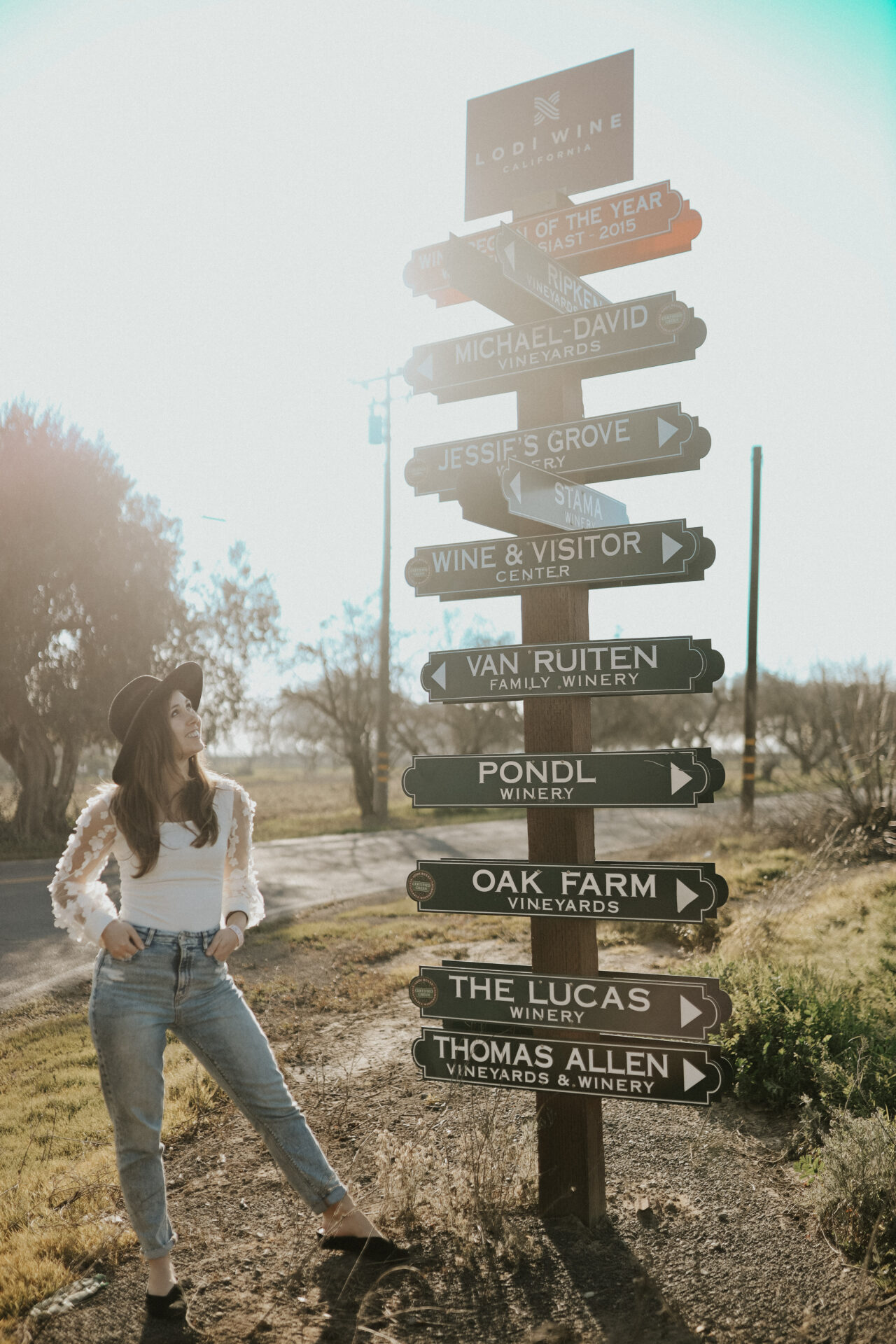 A lady standing close to a sign board