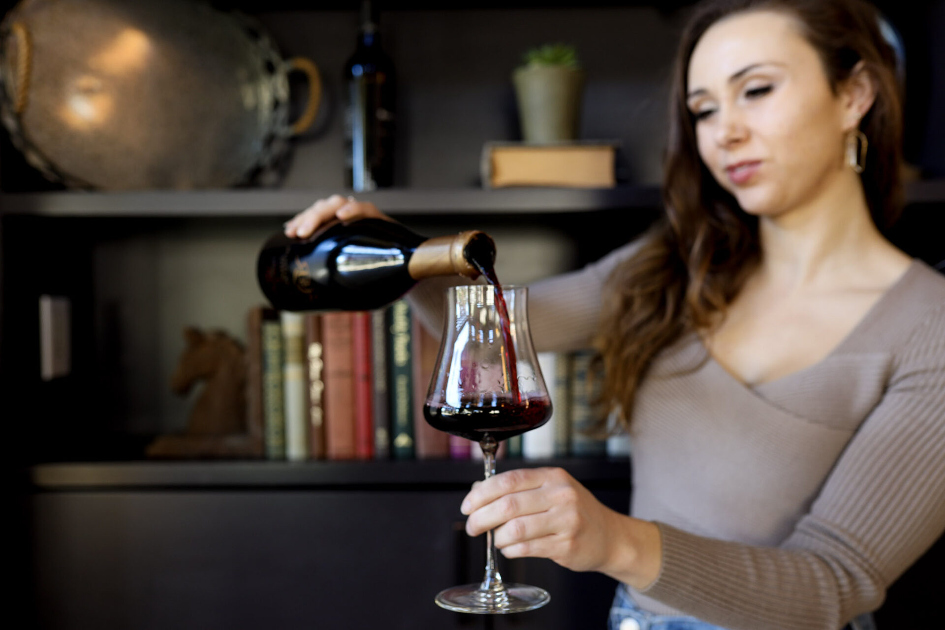 Paige pouring a glass of wine