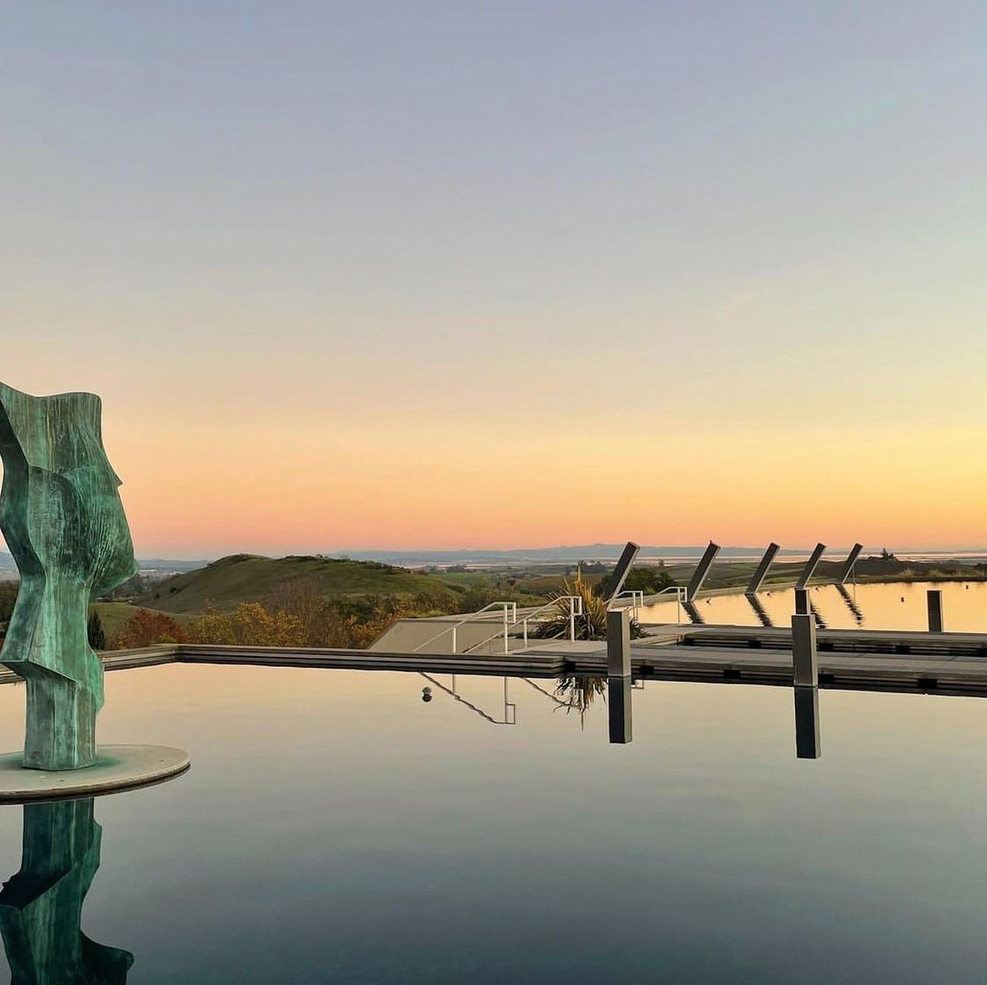 Sculpture garden among infinity pool at sunset