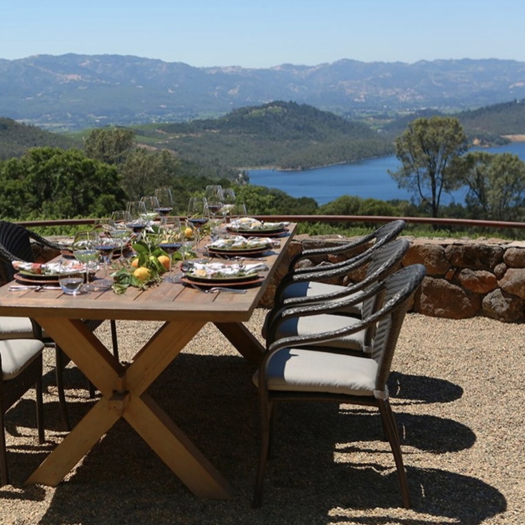 Table and chairs set on patio overlooking mountain and lake