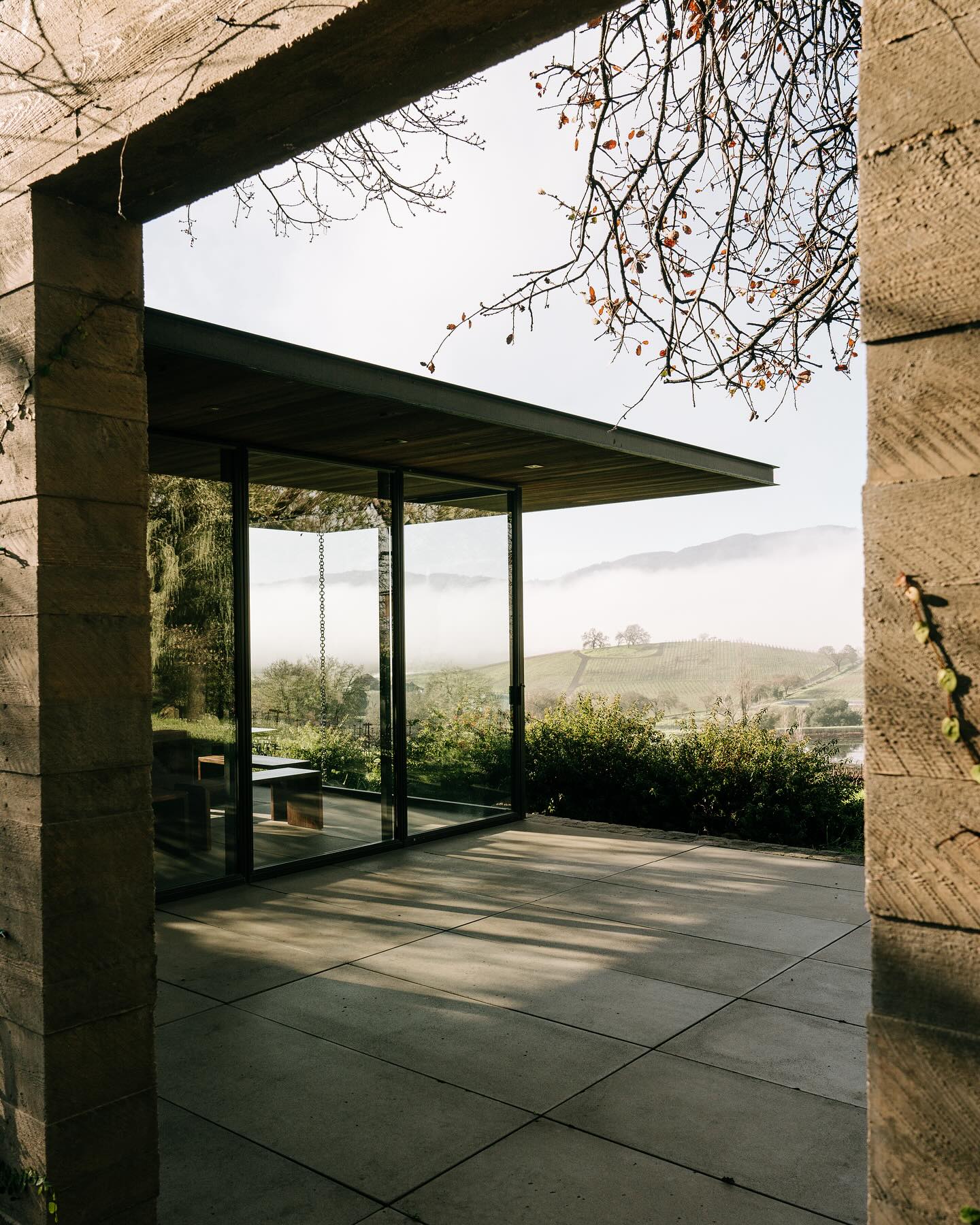 Floor to ceiling glass window tasting room with courtyard