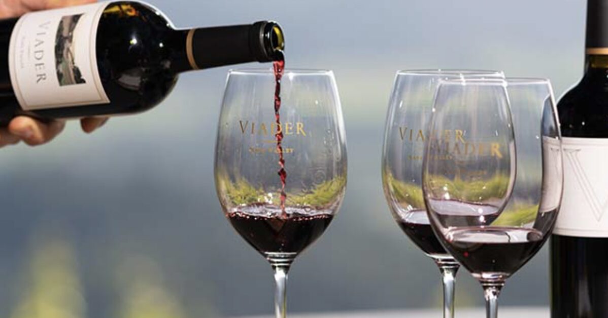 Red wine being poured into a glass with blurred background